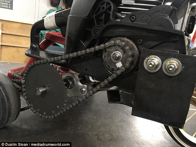 The saw of the chainsaw was removed and replaced with a welded-on sprocket (pictured right) which was then attached to the trike with a chain