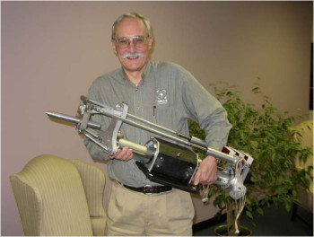 Dr. John Olsen holding a tilting head waterjet with two linear actuators. (Image courtesy of Omax.)